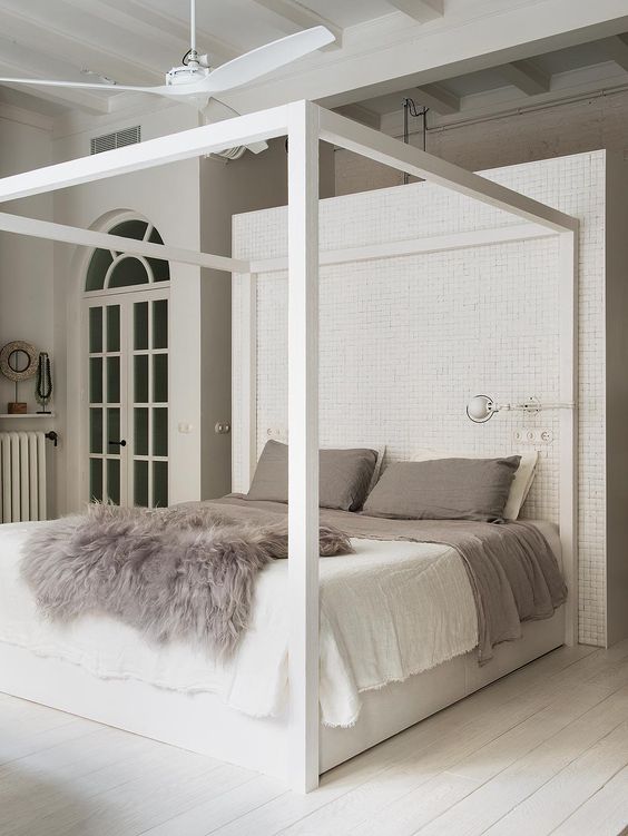 A canopy bed with a trendy ceiling fan carries a spectacle in design and helps cool off those summers. The brick behind the bed is highly unique to make this bedroom stand out.