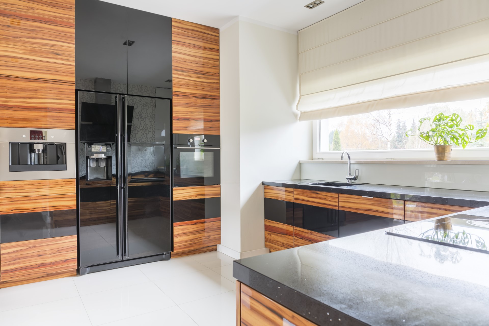 Nothing displays elegance quite like out of the ordinary in this burned stained wood theme. This kitchen emphasizes on the glossy ebony tones that help bring out the fine grain in the burnt wood cabinets. This high level gloss is not the cheapest style, but it gives that surreal, abstract, nature type of feel.