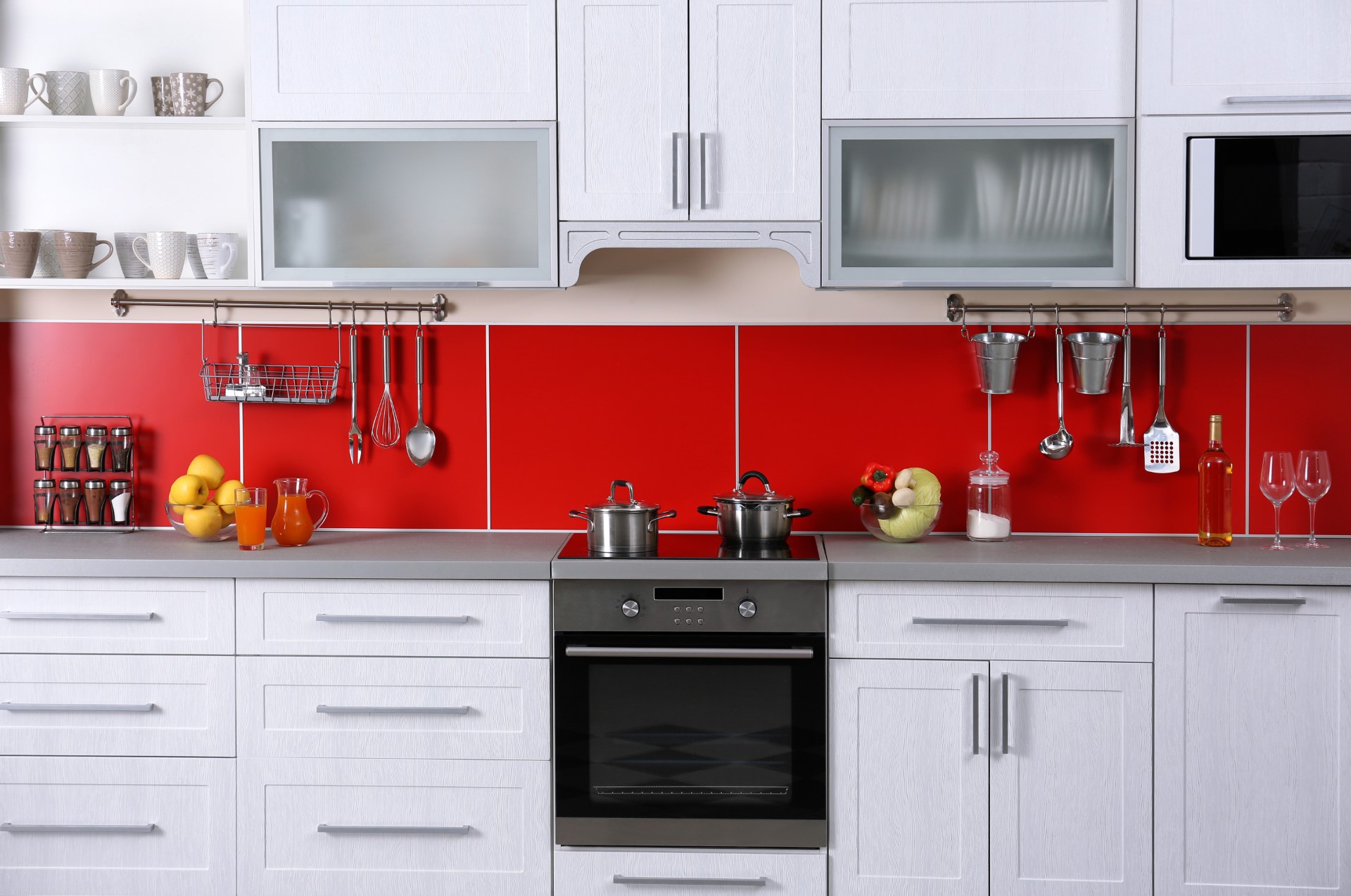 If you're looking for a design that shows character and personality, there's no better way to show it than a bright color like red as a backsplash to your countertop. Something like this would be great for a college dorm, or just an all-around fun person.