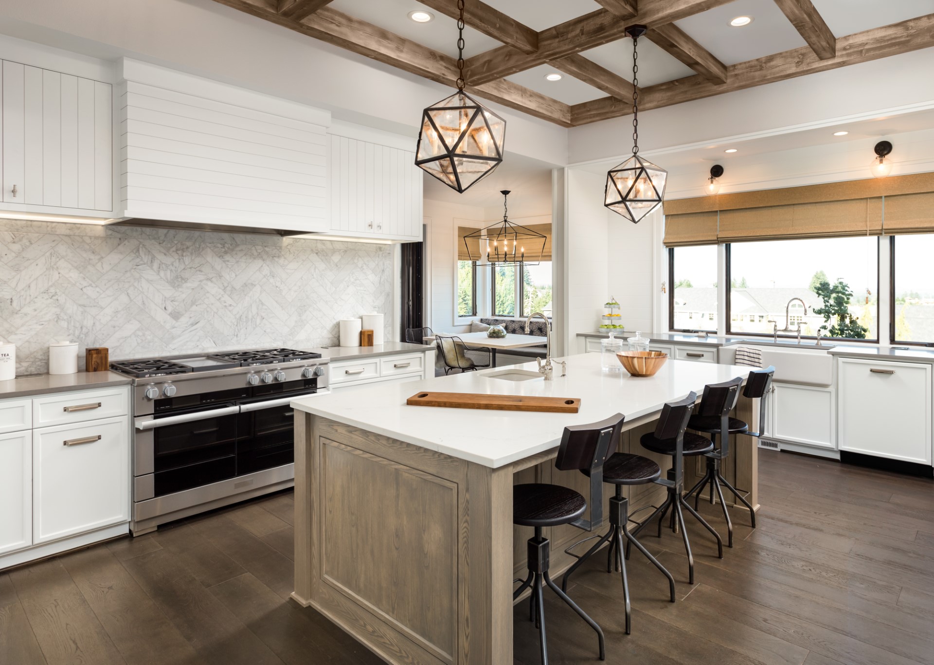 This kitchen takes on a very coastal feel, but the main decoration is the pendant lights with distinct geometric ambiance that catches your eye. The stained wood beams help make this layout truly majestic. The call