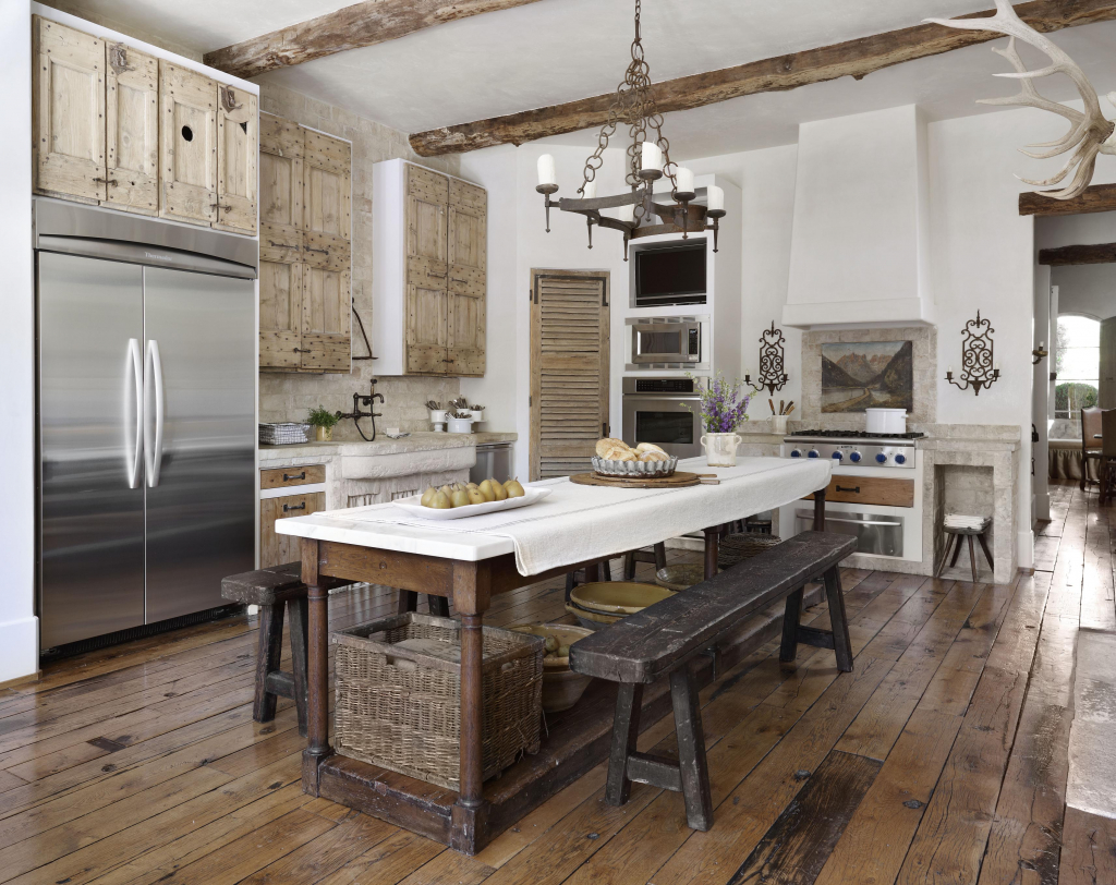 When you're going for a modern farmhouse rustic feeling kitchen, dark floors are going to be a lot more durable and easier to maintain. This one features bench seats and an island countertop is well as a built-in wall stove to cook to your hearts content.