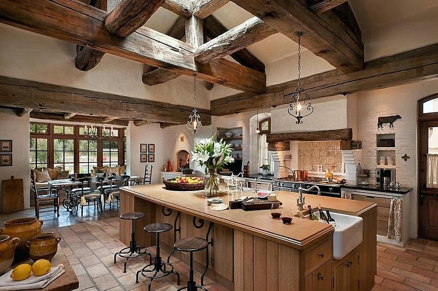 This is great if you have vaulted ceilings going with the more aggressive stained wood beam to maximize that country farmhouse feeling. It's great to have an island countertop with seeding and a Wolf stovetop in this luxury kitchen.