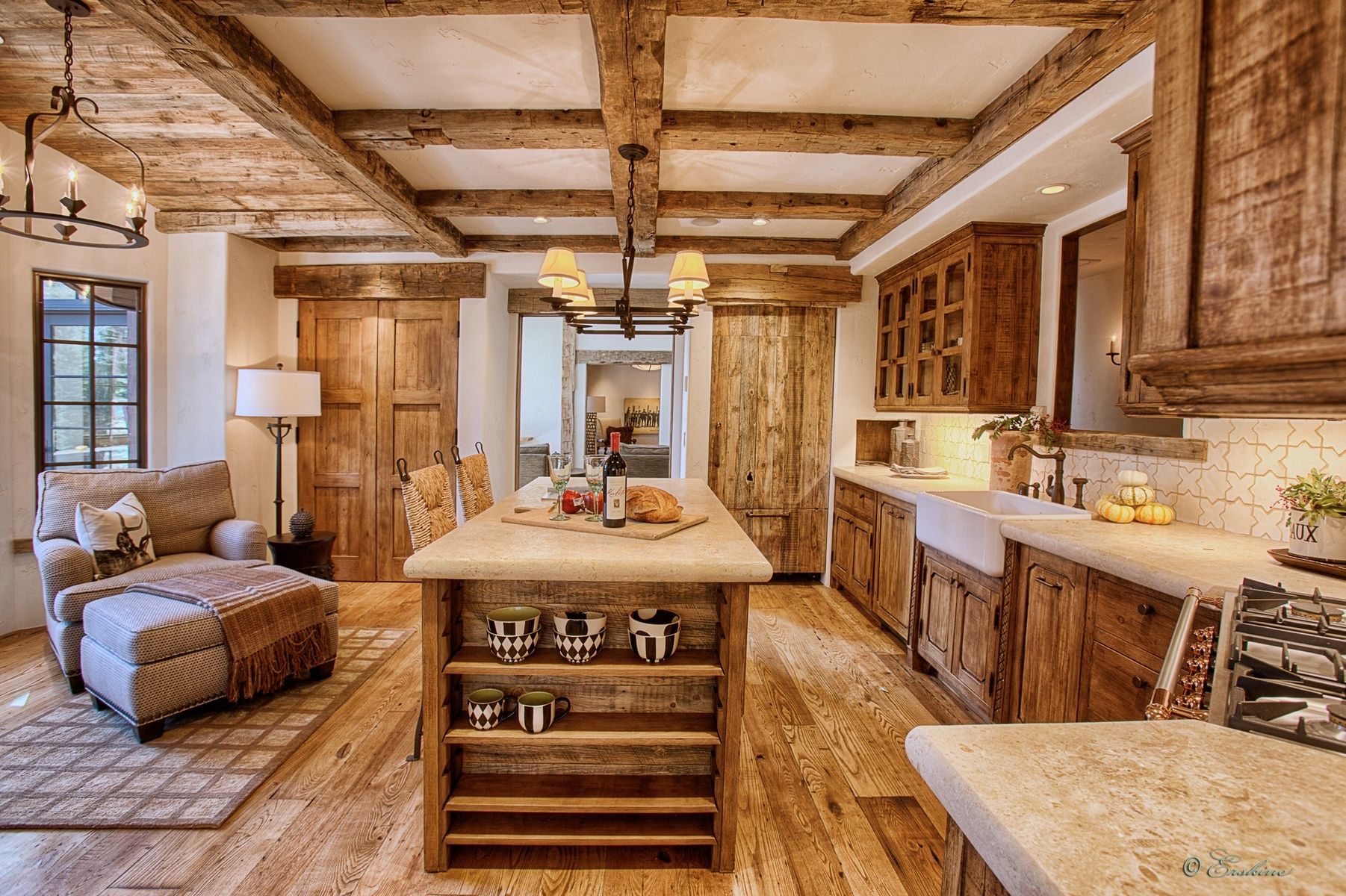 Adding wood beams to your ceiling provides a lot of warps for your kitchen. When you're remodeling your kitchen it might be a good idea to add island countertop with seating to help maximize space.