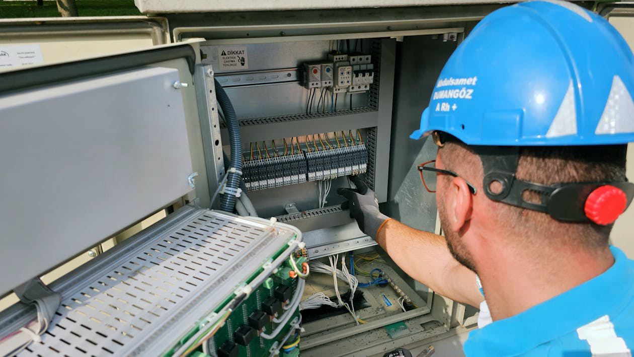 An electrician checking a fuse box